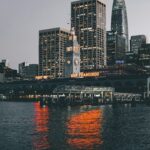 Luxury ocean cruise liner docked at the Manhattan Cruise Terminal on the Hudson River with Midtown skyscrapers in the background