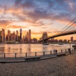 Panoramic view of Brooklyn Bridge and Manhattan skyline at sunset during a one-day luxury New York City tour