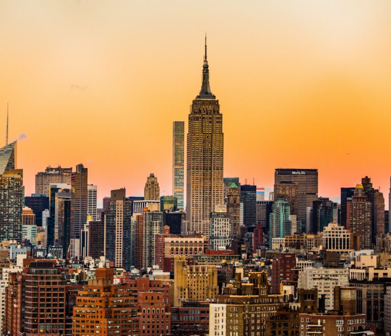 Stylish solo traveler standing confidently amidst the historic architecture and vibrant morning street life of Manhattan